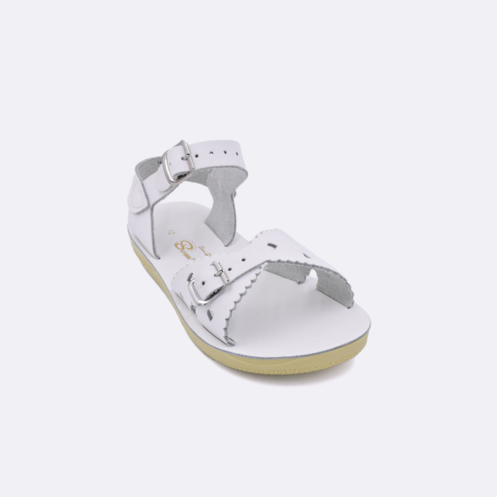 One little kid sized 1400 Sweetheart style sandal with white straps and a white insole. Facing left to right diagonally.