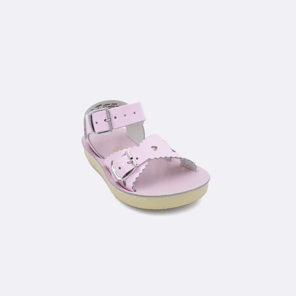 One toddler sized 1400 Sweetheart style sandal with shiny pink straps and a shiny pink insole. Facing left to right diagonally.