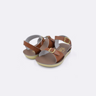 Two toddler sized 1700 Surfer style sandals with tan straps and beige insoles. Both pushed together facing the camera diagonally.