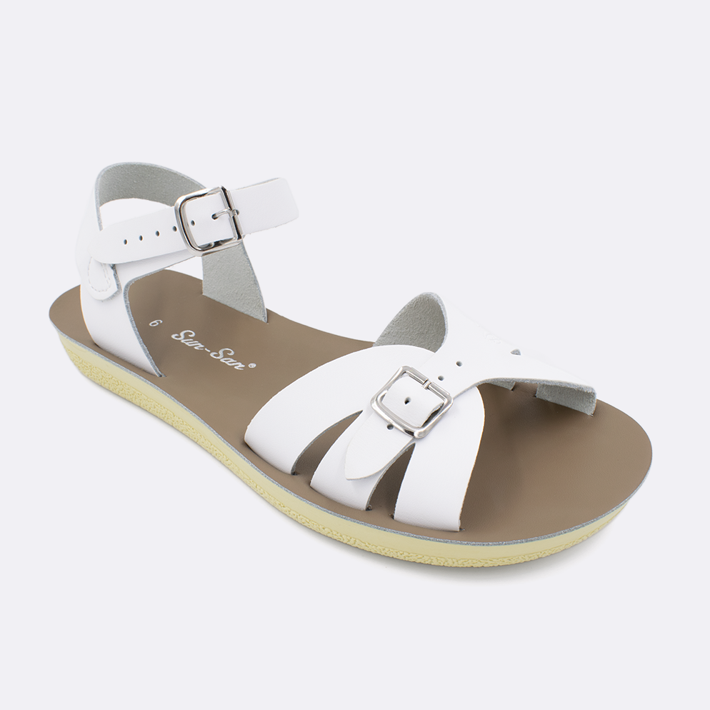 One Women's sized 1900 Boardwalk style sandal with white straps and a beige insole. Facing left to right diagonally.