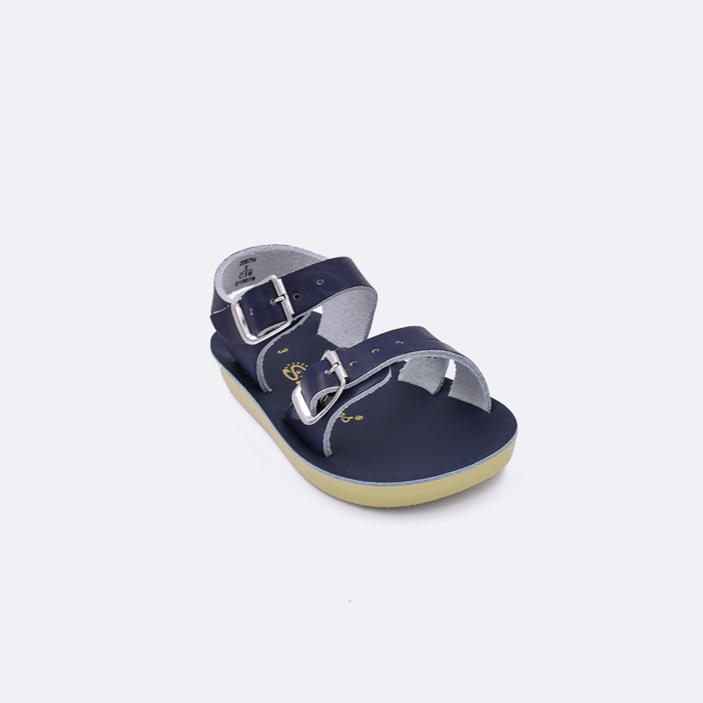 One baby sized 2000 Sea Wee style sandal with navy straps and a navy insole. Facing left to right diagonally. 