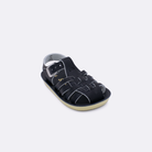 One baby sized 4200 Sailor style sandal with black straps and a black insole. Facing left to right diagonally.