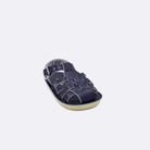One baby sized 4200 Sailor style sandal with navy straps and a navy insole. Facing left to right diagonally.