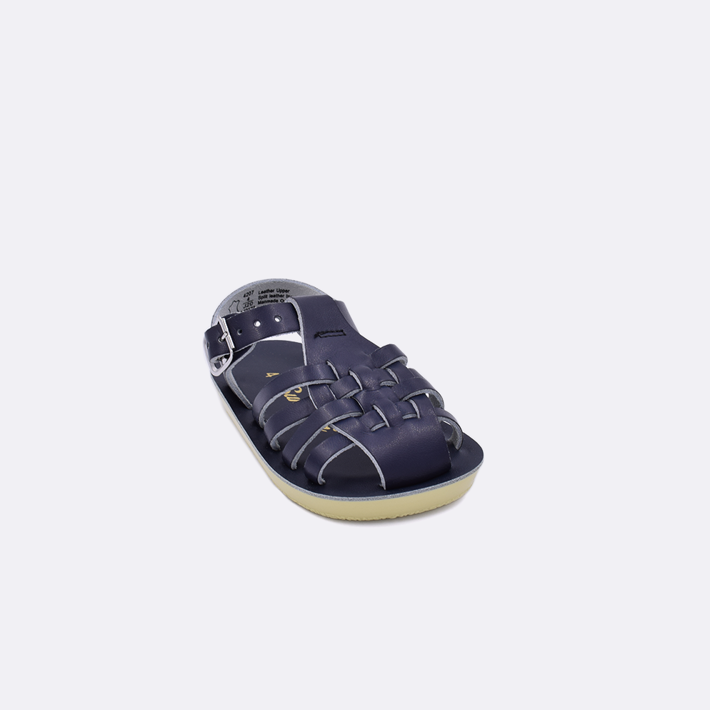 One baby sized 4200 Sailor style sandal with navy straps and a navy insole. Facing left to right diagonally.
