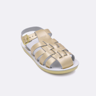 One little kid sized 4200 Sailor style sandal with gold straps and a white insole. Facing left to right diagonally.