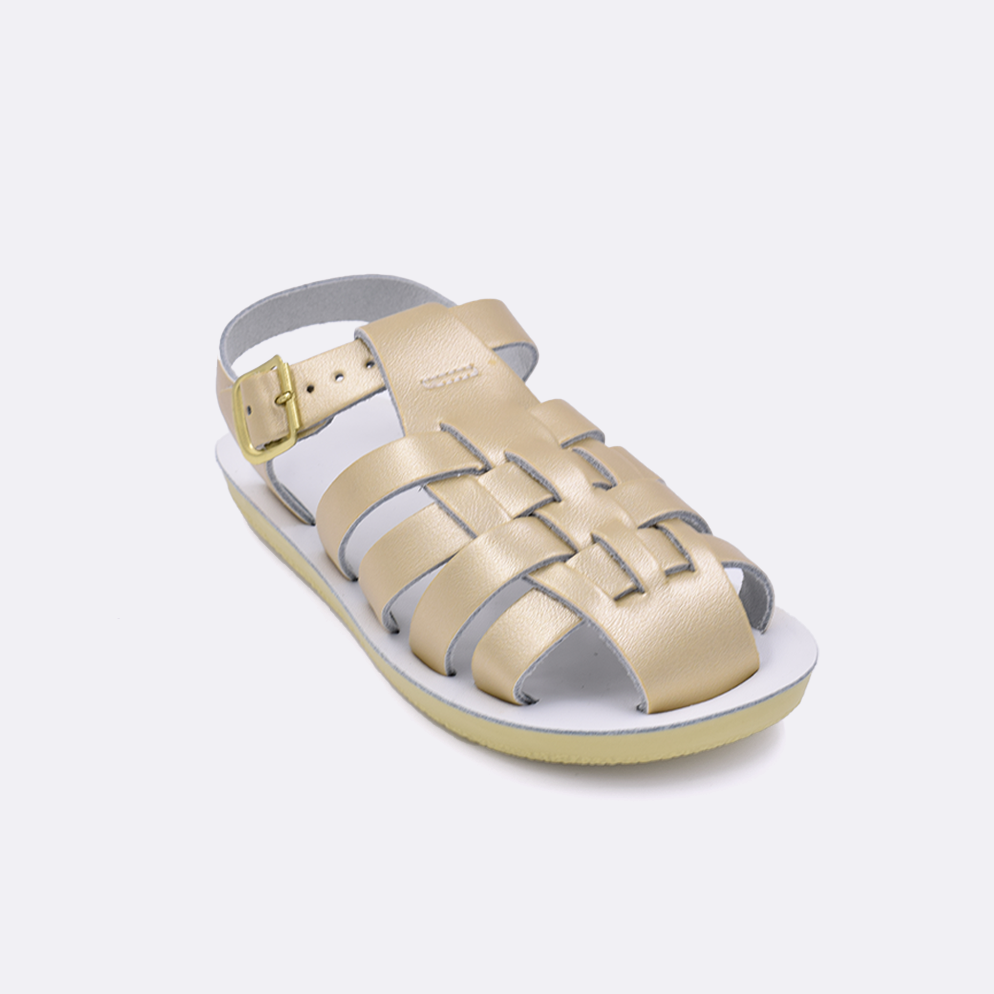 One little kid sized 4200 Sailor style sandal with gold straps and a white insole. Facing left to right diagonally.