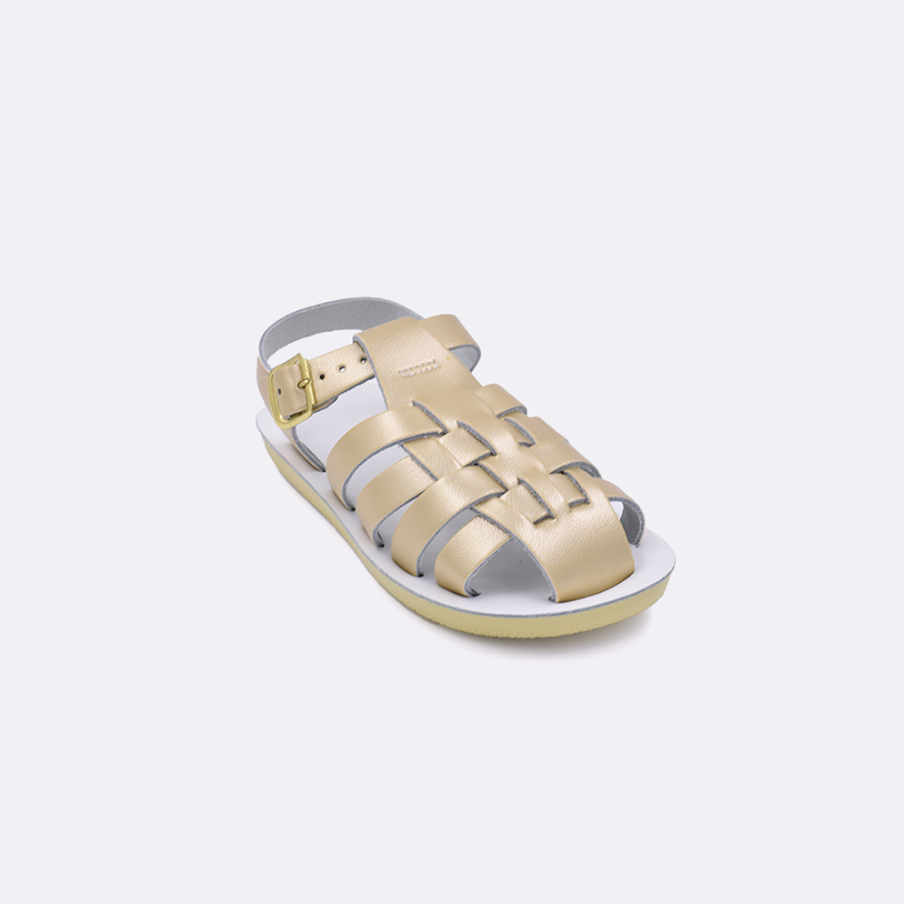 One toddler sized 4200 Sailor style sandal with gold straps and a white insole. Facing left to right diagonally.