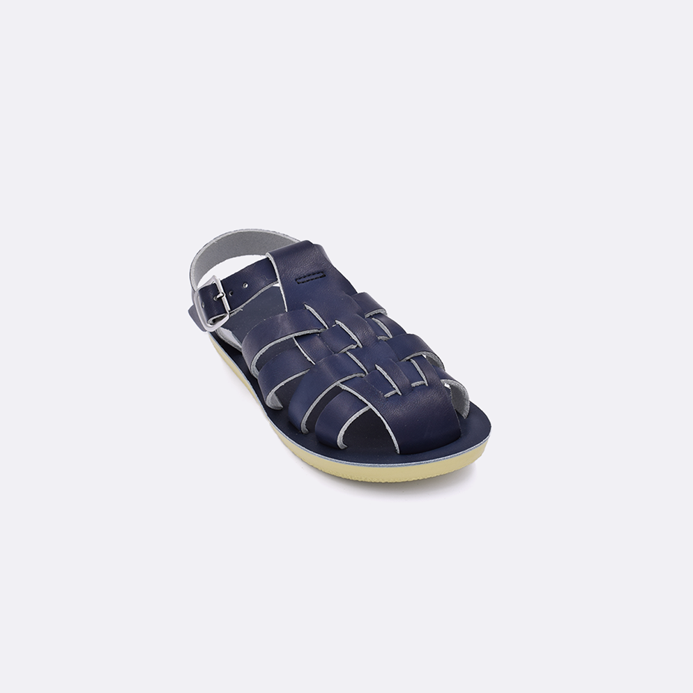 One toddler sized 4200 Sailor style sandal with navy straps and a navy insole. Facing left to right diagonally.