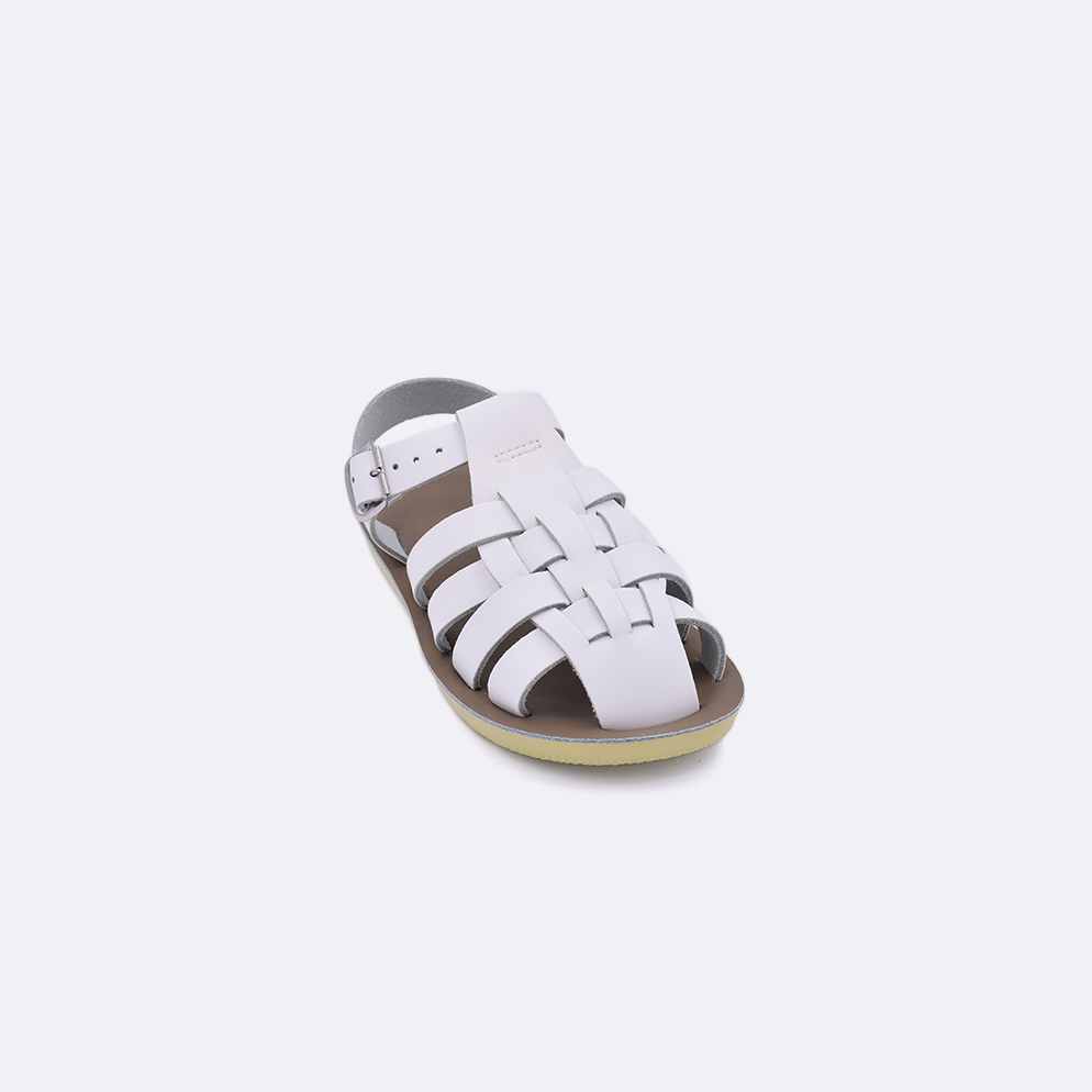 One toddler sized 4200 Sailor style sandal with white straps and a beige insole. Facing left to right diagonally.