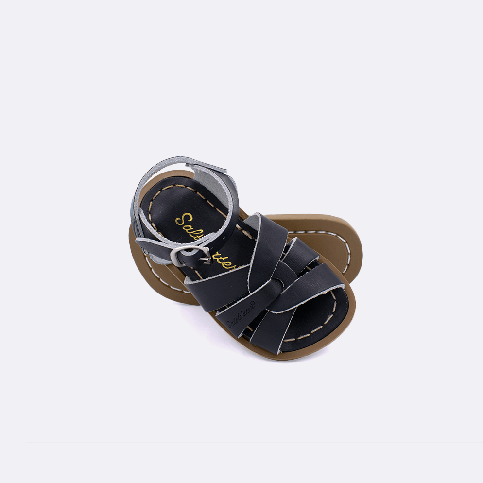 Two 800 Original style sandals color black.  One standing with the sole facing the camera. The second is laying diagonally over the top left edge of the sole.	Baby size
