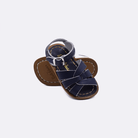 Two baby size 800 Original style sandals color navy.  One standing with the sole facing the camera. The second is laying diagonally over the top left edge of the sole.