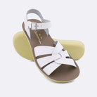 Two women's sized 8000 Swimmer style sandals with white straps and beige insoles.  One standing with the sole facing the camera. The second is laying diagonally over the top left edge of the sole.