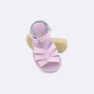 Two toddler sized 8000 Swimmer style sandals with shiny pink straps and shiny pink insoles.  One standing with the sole facing the camera. The second is laying diagonally over the top left edge of the sole.