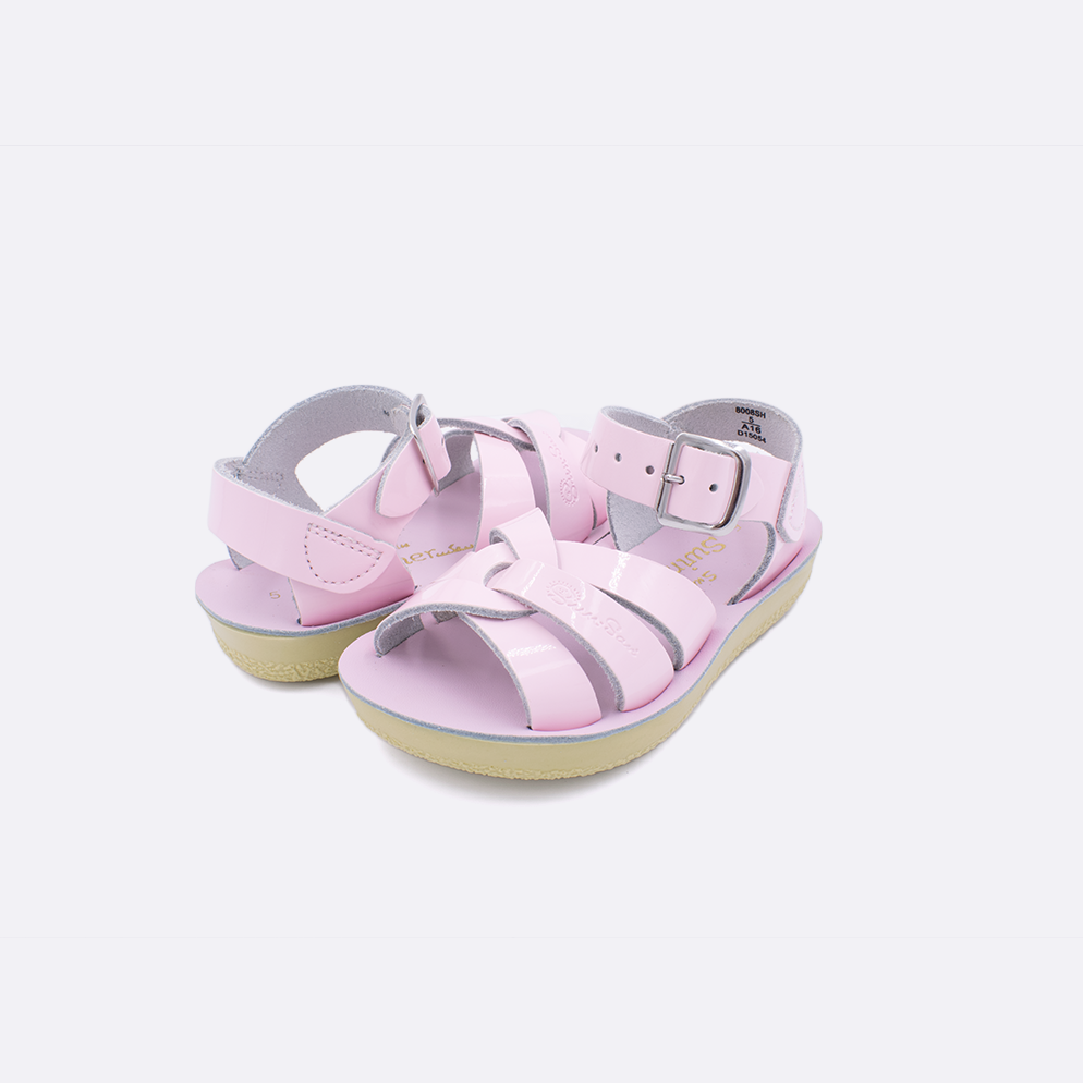Two toddler sized 8000 Swimmer style sandals with shiny pink straps and shiny pink insoles. Both pushed together facing the camera diagonally.