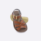 Two toddler sized 8000 Swimmer style sandals with tan straps and beige insoles.  One standing with the sole facing the camera. The second is laying diagonally over the top left edge of the sole.