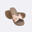 Two 9900 Classic Slide style sandals color rose gold.  One standing with the sole facing the camera. The second is laying diagonally over the top left edge of the sole.	Little Kid Size.