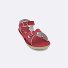 One little kid sized 1400 Sweetheart style sandal with red straps and a red insole. Facing left to right diagonally. 