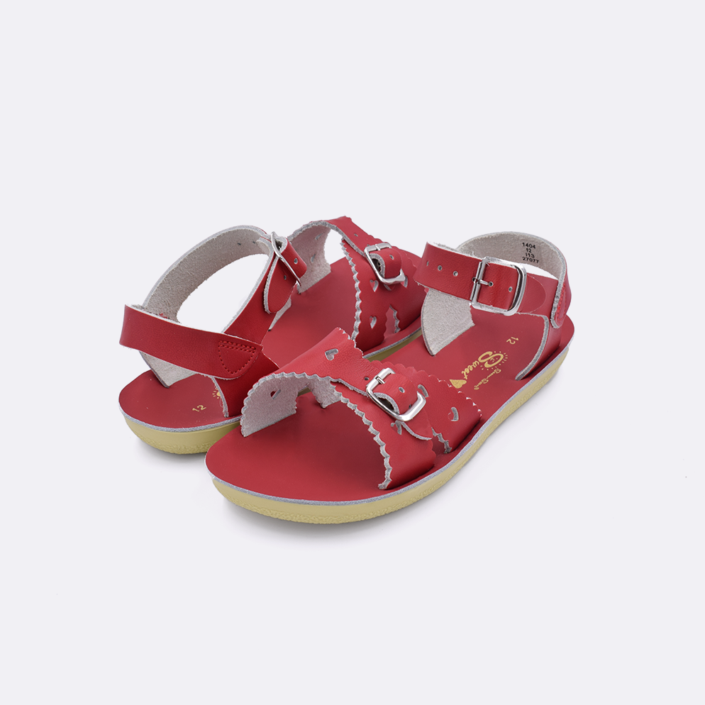 Two little kid sized 1400 Sweetheart style sandals with red straps and red insoles. Both pushed together facing the camera diagonally.