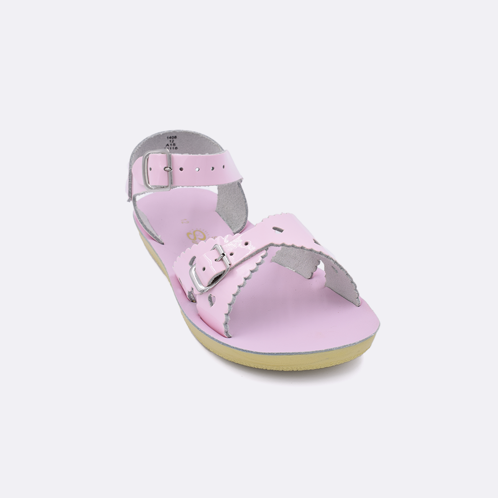 One little kid sized 1400 Sweetheart style sandal with shiny pink straps and a shiny pink insole. Facing left to right diagonally. 