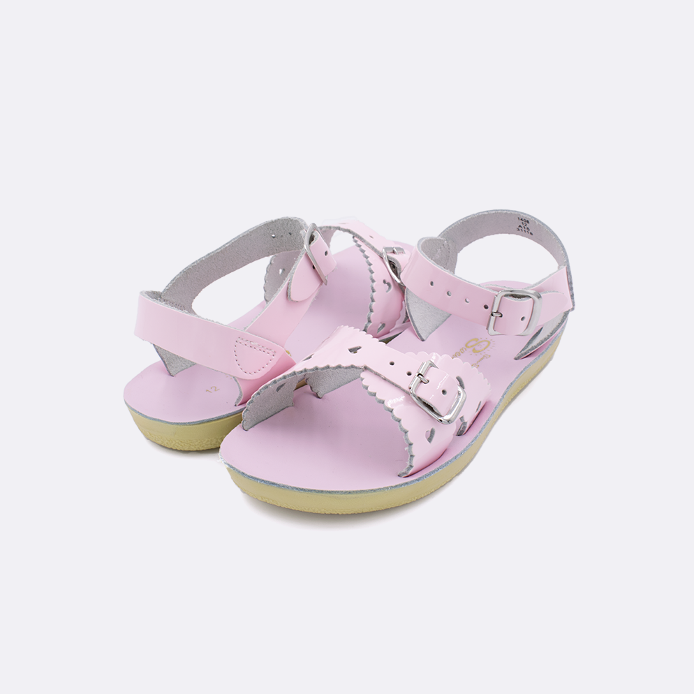 Two little kid sized 1400 Sweetheart style sandals with shiny pink straps and shiny pink insoles. Both pushed together facing the camera diagonally.