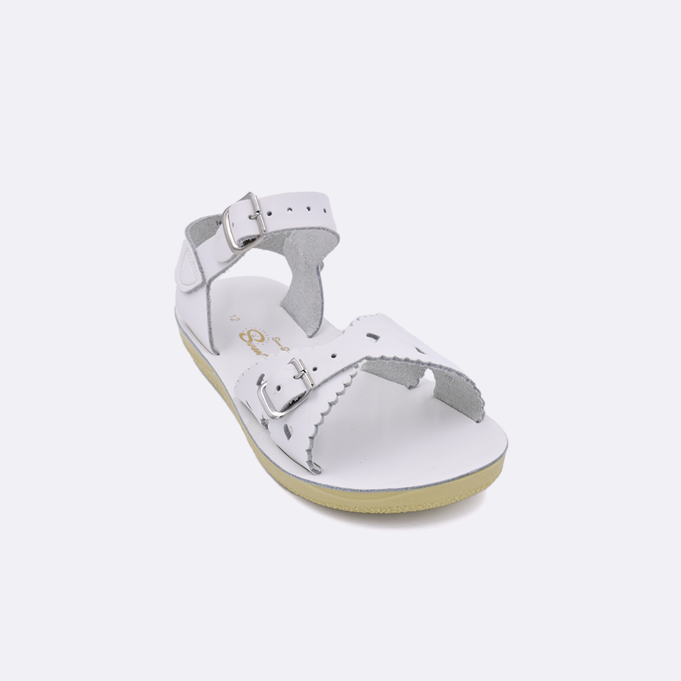 One little kid sized 1400 Sweetheart style sandal with white straps and a white insole. Facing left to right diagonally. 