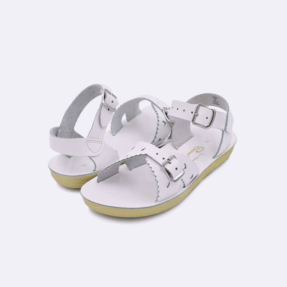 Two little kid sized 1400 Sweetheart style sandals with white straps and white insoles. Both pushed together facing the camera diagonally.