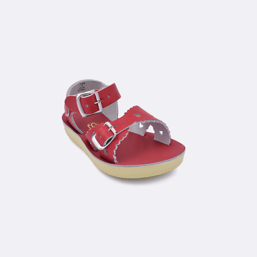 One toddler sized 1400 Sweetheart style sandal with red straps and a red insole. Facing left to right diagonally. 