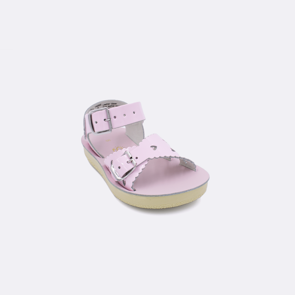 One toddler sized 1400 Sweetheart style sandal with shiny pink straps and a shiny pink insole. Facing left to right diagonally. 