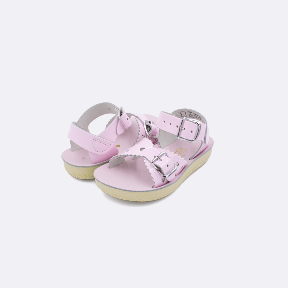 Two toddler sized 1400 Sweetheart style sandals with shiny pink straps and shiny pink insoles. Both pushed together facing the camera diagonally.