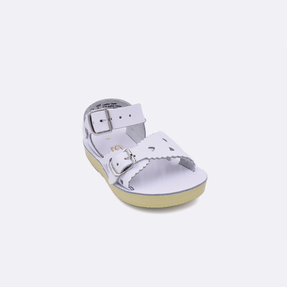 One toddler sized 1400 Sweetheart style sandal with white straps and a white insole. Facing left to right diagonally. 