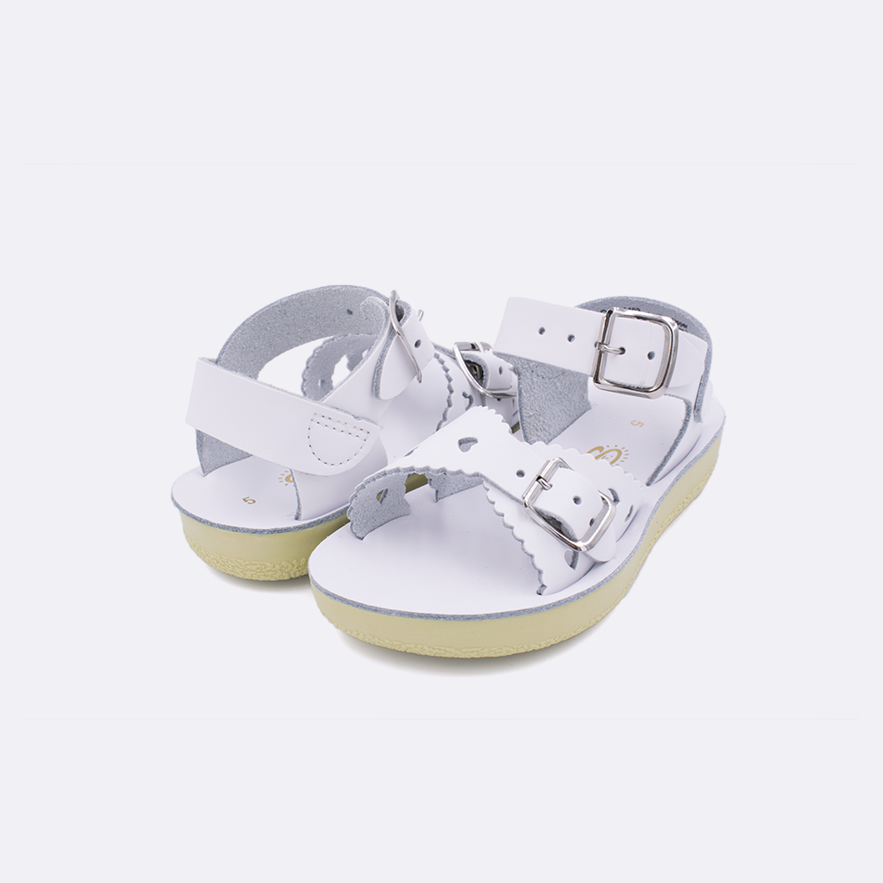 Two toddler sized 1400 Sweetheart style sandals with white straps and white insoles. Both pushed together facing the camera diagonally.