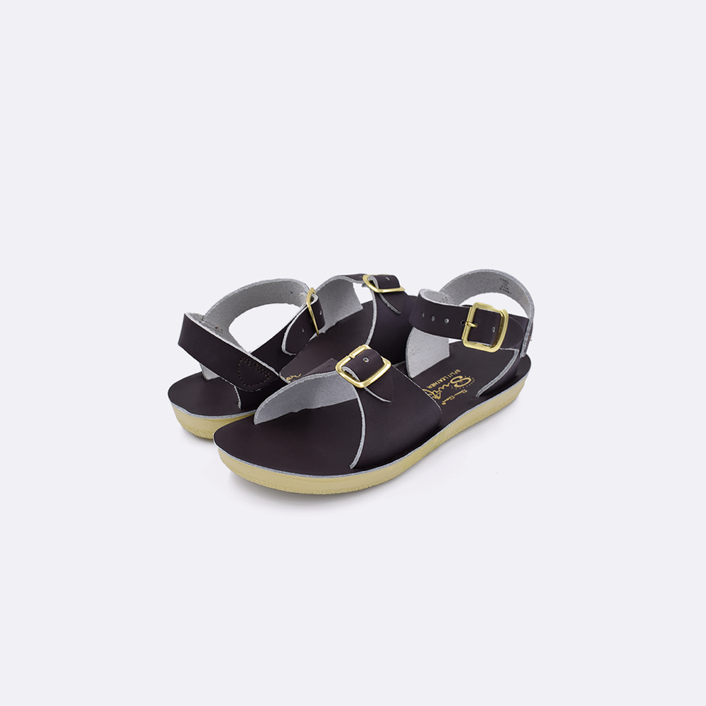 Two toddler sized 1700 Surfer style sandals with brown straps and brown insoles. Both pushed together facing the camera diagonally.