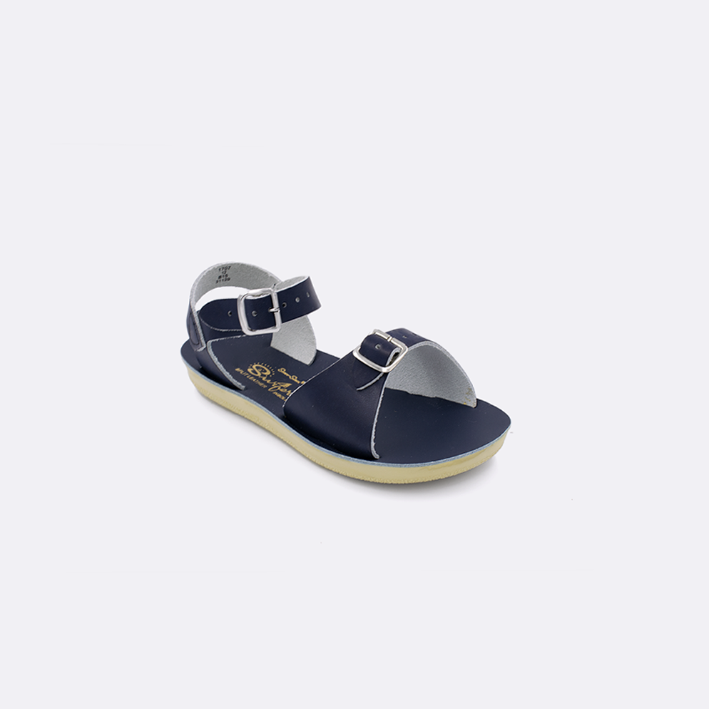One toddler sized 1700 Surfer style sandal with navy straps and a navy insole. Facing left to right diagonally. 