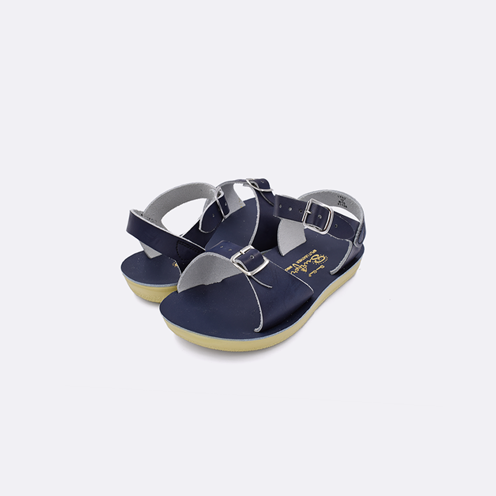 Two toddler sized 1700 Surfer style sandals with navy straps and navy insoles. Both pushed together facing the camera diagonally.