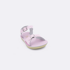 One toddler sized 1700 Surfer style sandal with shiny pink straps and a shiny pink insole. Facing left to right diagonally. 