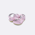 Two toddler sized 1700 Surfer style sandals with shiny pink straps and shiny pink insoles. Both pushed together facing the camera diagonally.