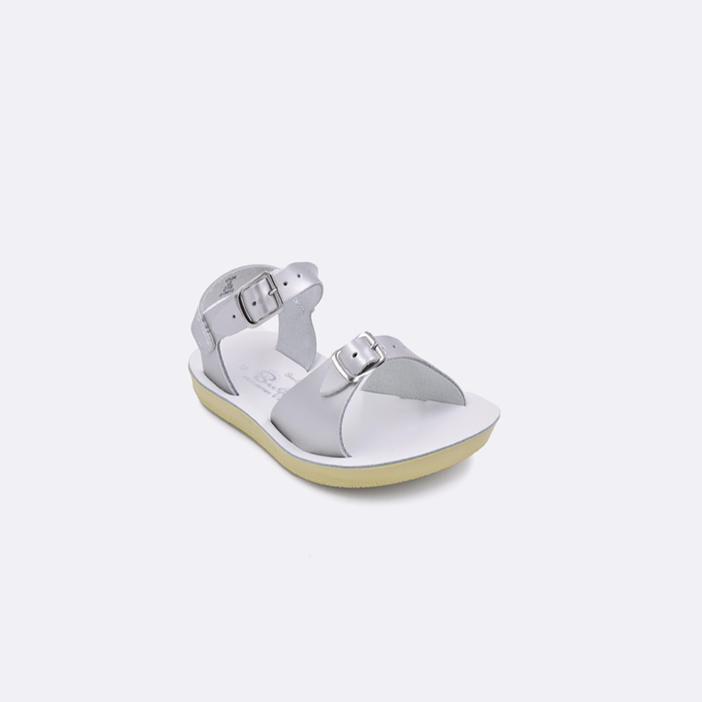 One toddler sized 1700 Surfer style sandal with silver straps and a white insole. Facing left to right diagonally. 