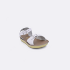 One toddler sized 1700 Surfer style sandal with white straps and a beige insole. Facing left to right diagonally. 
