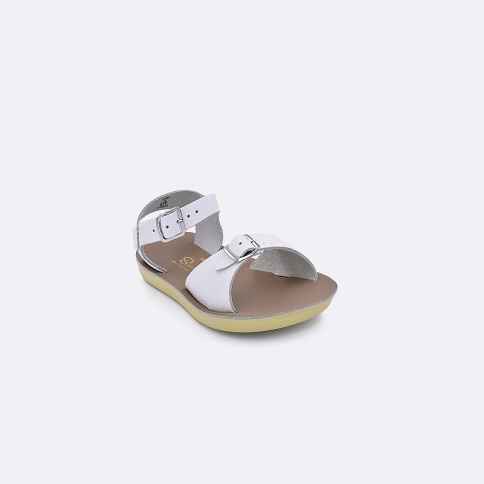 One toddler sized 1700 Surfer style sandal with white straps and a beige insole. Facing left to right diagonally. 