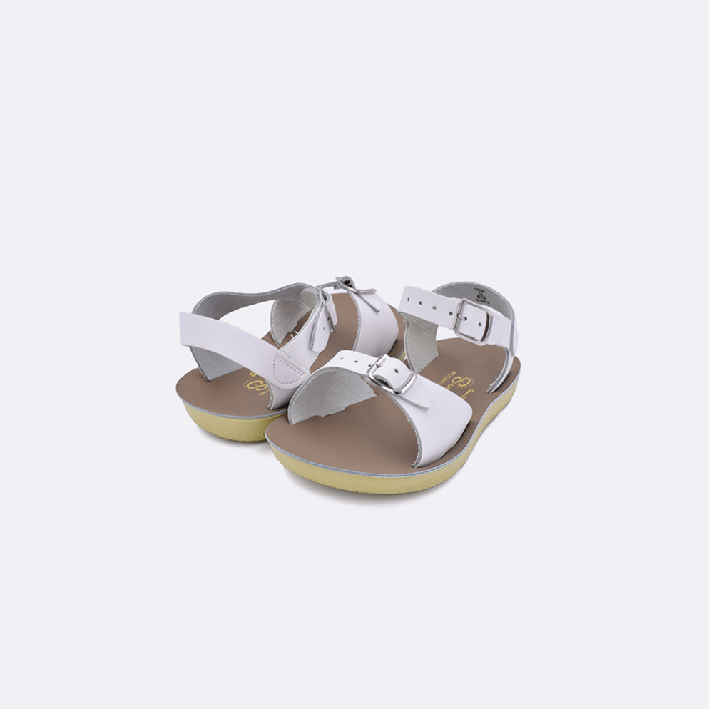 Two toddler sized 1700 Surfer style sandals with white straps and beige insoles. Both pushed together facing the camera diagonally.