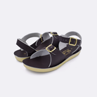 Two little kid sized 1700 Surfer style sandals with brown straps and brown insoles. Both pushed together facing the camera diagonally.