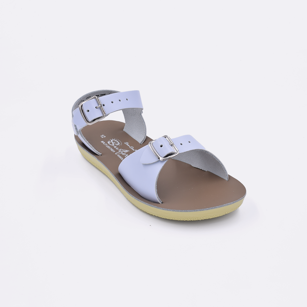 One little kid sized 1700 Surfer style sandal with light blue straps and a beige insole. Facing left to right diagonally. 
