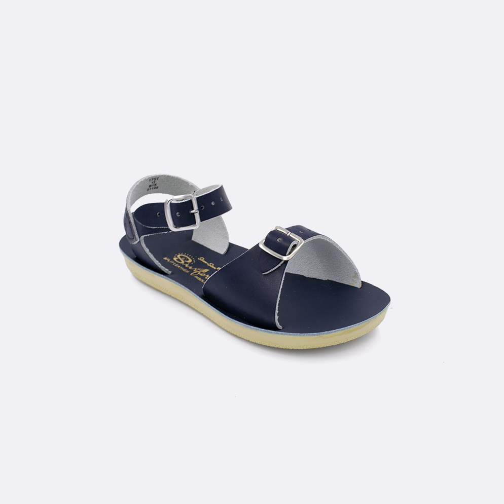 One little kid sized 1700 Surfer style sandal with navy straps and a navy insole. Facing left to right diagonally. 