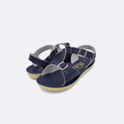 Two little kid sized 1700 Surfer style sandals with navy straps and navy insoles. Both pushed together facing the camera diagonally.