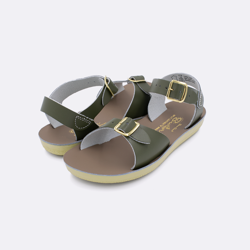 Two  little kid sized 1700 Surfer style sandals with olive straps and beige insoles. Both pushed together facing the camera diagonally.