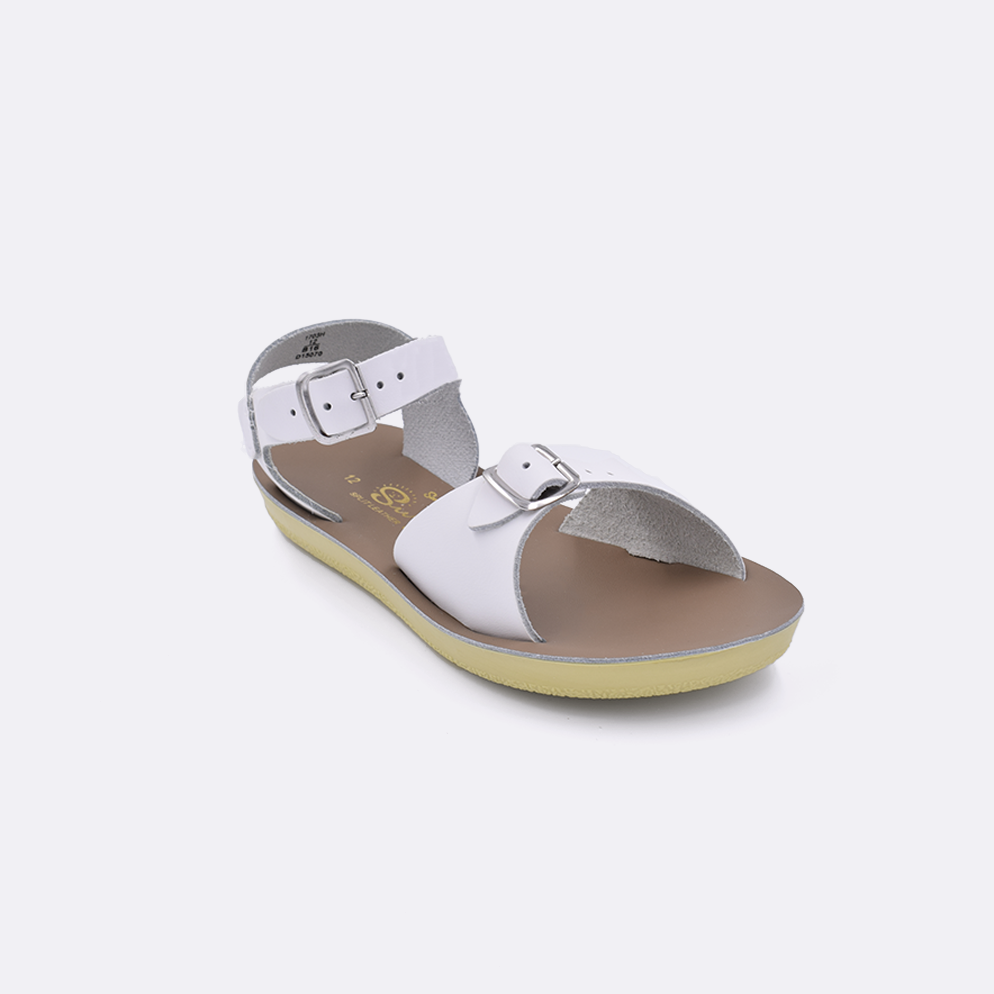 One little kid sized 1700 Surfer style sandal with white straps and a beige insole. Facing left to right diagonally. 