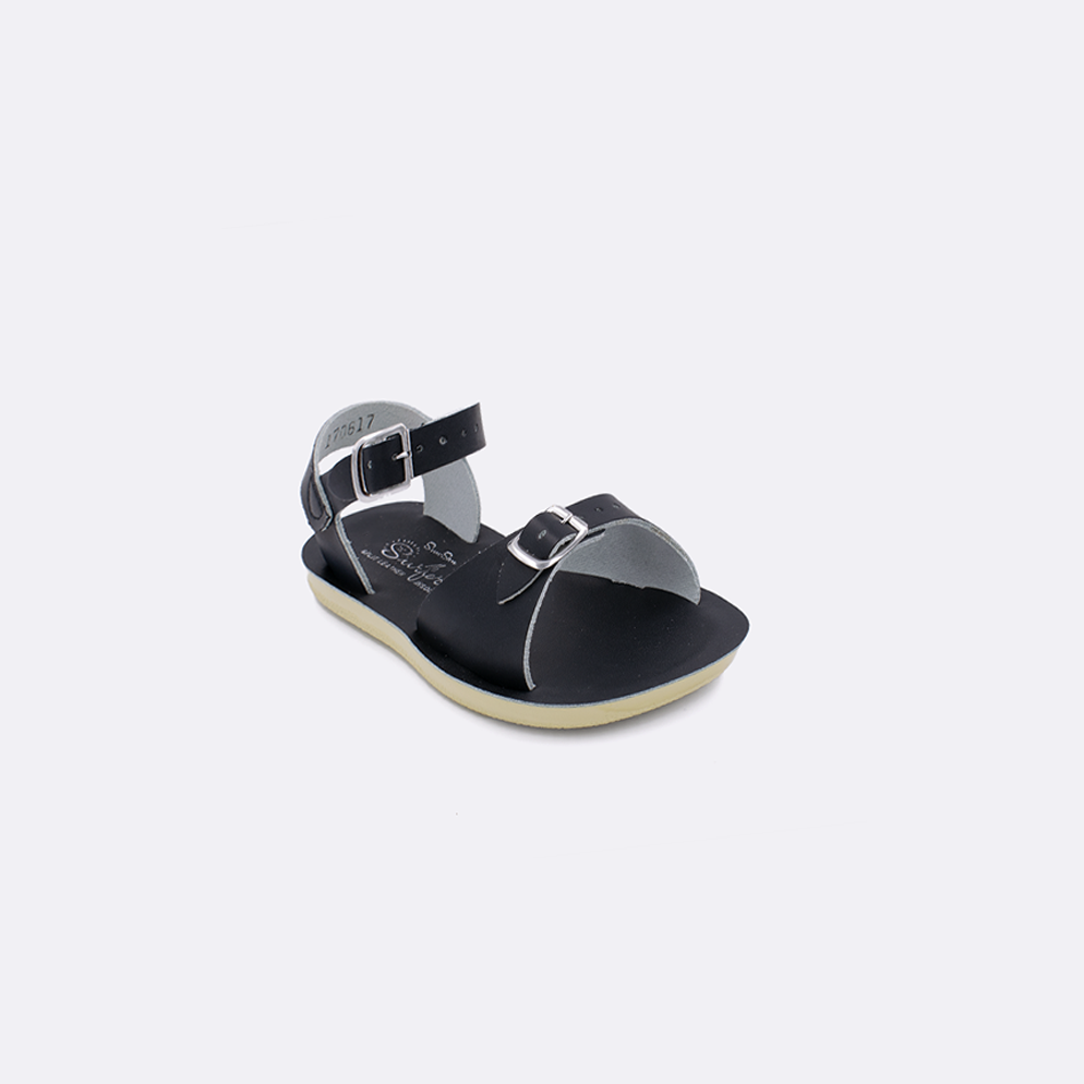 One toddler sized 1700 Surfer style sandal with black straps and a black insole. Facing left to right diagonally. 
