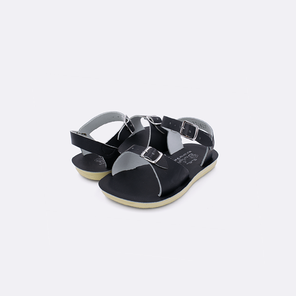 Two toddler sized 1700 Surfer style sandals with black straps and black insoles. Both pushed together facing the camera diagonally.