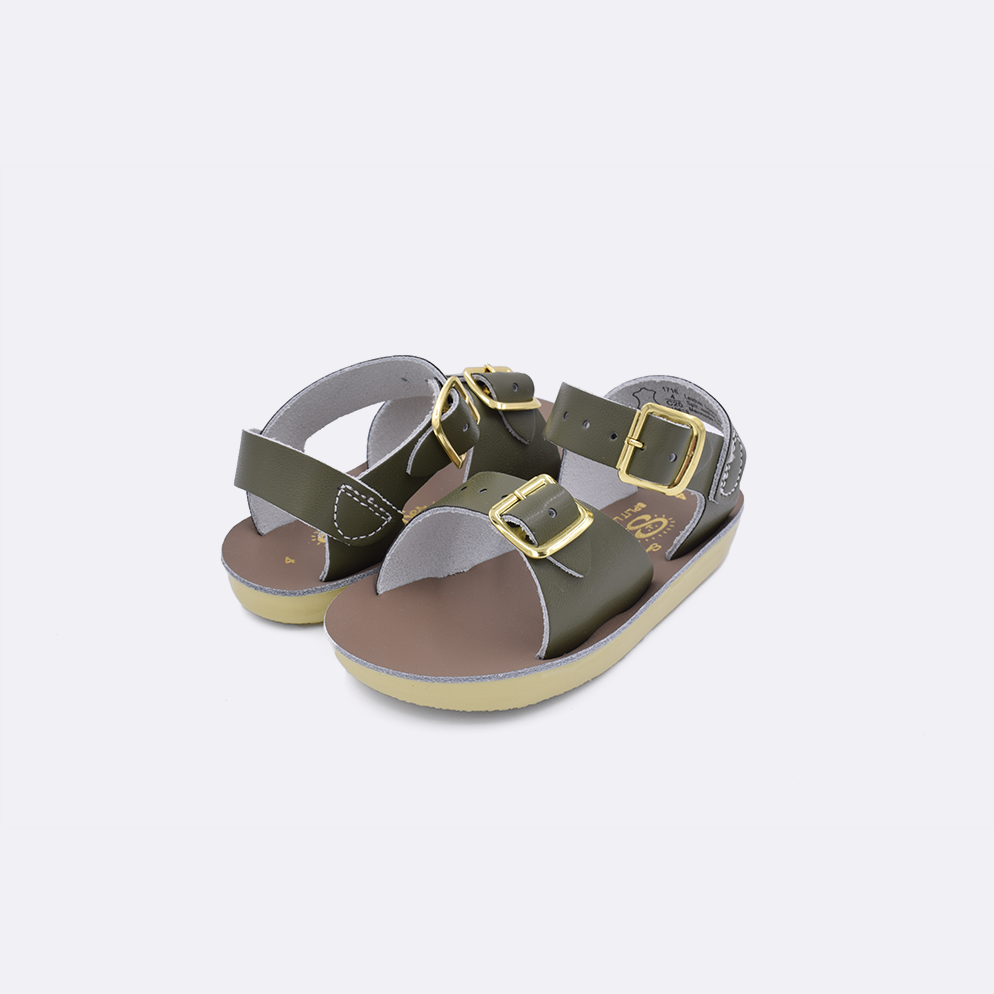Two  baby sized 1700 Surfer style sandals with olive straps and beige insoles. Both pushed together facing the camera diagonally.