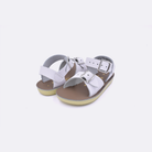 Two baby sized 1700 Surfer style sandals with white straps and beige insoles. Both pushed together facing the camera diagonally.